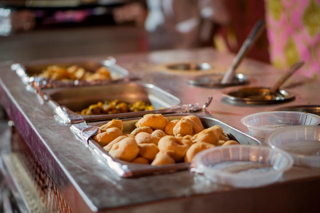 Indian food catering buffet spread with silver chafing dishes - Indian food catering near me